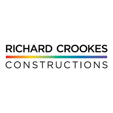 Richard Crookes Richard Crookes Constructions logo – distinctive red monogram paired with company name.